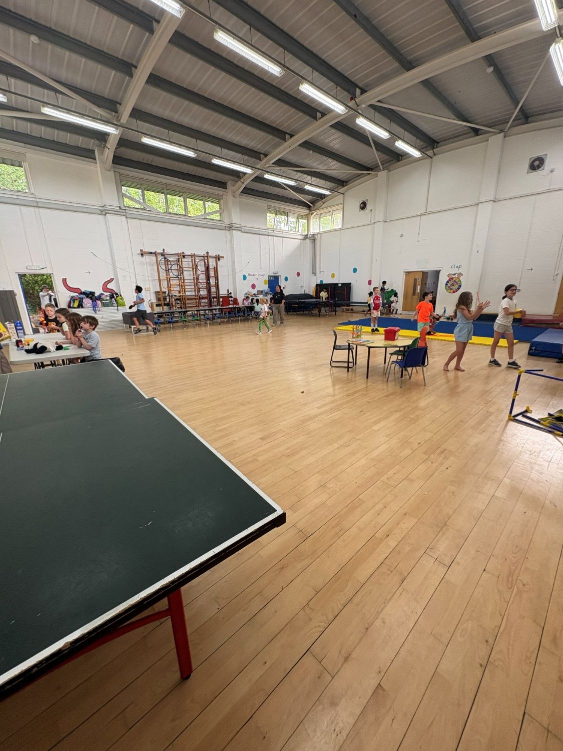 The school hall at Essence Sports camp with children playing table tennis, crafts and gymnastics