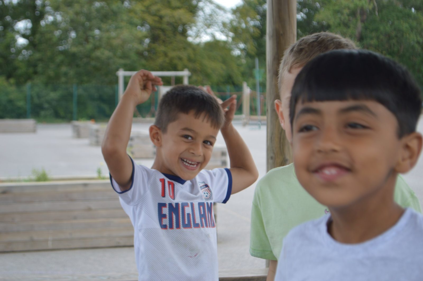 Two children laughing together in the playground at camp